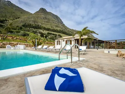 a resort with a swimming pool and mountains in the background at Villa Mari e Monti by Interhome in Castellammare del Golfo