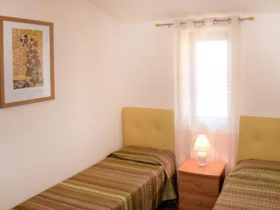 two beds in a room with a window at Villa Flavia by Interhome in Castellammare del Golfo