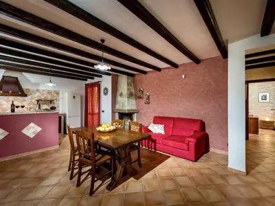 a living room with a table and a red couch at Villa Flavia by Interhome in Castellammare del Golfo