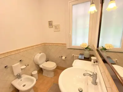a bathroom with a sink and a toilet and a sink at Villa Le Muse by Interhome in Scopello
