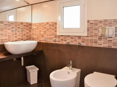 a bathroom with a sink and a toilet at Villa Le Muse by Interhome in Scopello