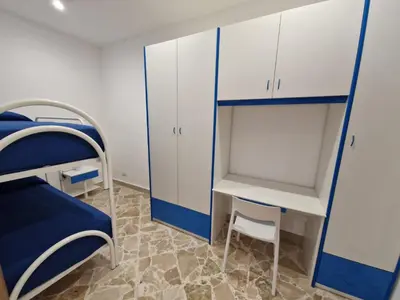 a room with a bed and a desk and a bunk bed at Casa Vera in Piana degli Albanesi