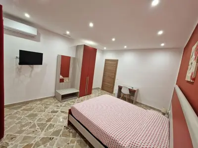 a bedroom with a bed and a sink and a tv at Casa Vera in Piana degli Albanesi