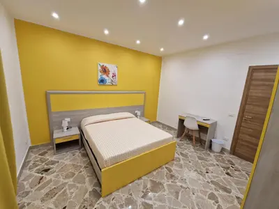 a bedroom with a bed and a desk and a table at Casa Vera in Piana degli Albanesi