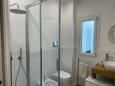 a bathroom with a shower and a toilet and a sink at Villa Lucia in Palermo