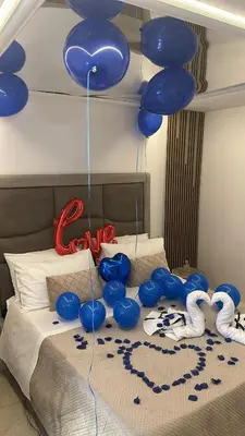a bunch of blue balloons hanging over a bed at Raquel suite and SPA in Palermo