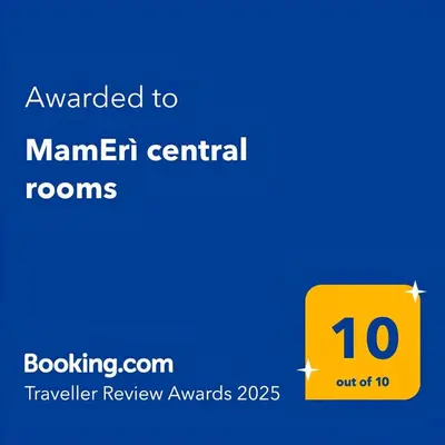 a yellow sign that reads awarded to manital central rooms at MamErì central rooms in Castellammare del Golfo