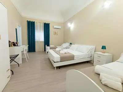 a bedroom with a white bed and a desk and a bed sidx sidx sidx sidx at Mille Memories Apartment in Palermo