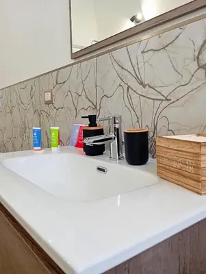 a bathroom counter with a sink and a mirror at Mille Memories Apartment in Palermo