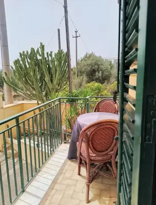 a patio with a table and chairs on a balcony at Villa Buscemi in Bagheria