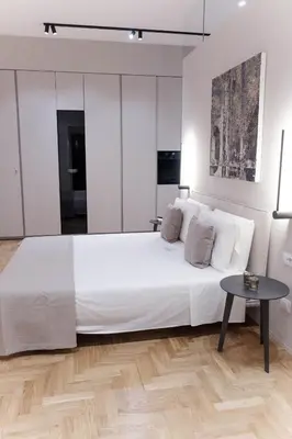 a bedroom with a large white bed and a table at Palazzo Giglio suite in Palermo