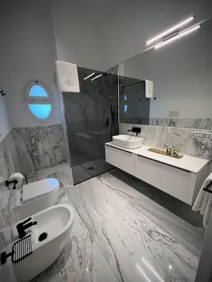 a bathroom with a sink and a toilet and a tub at Palazzo Giglio suite in Palermo