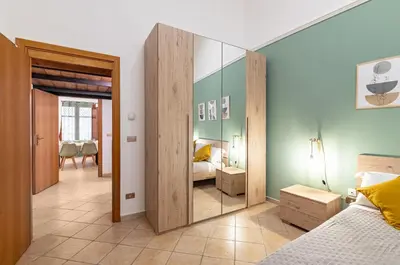 a bedroom with a mirror and a bed at GuestHost - Your Home at the Cathedral - Palermo Cozy Flat in Palermo