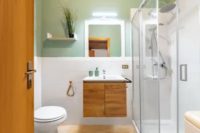 a bathroom with a shower and a toilet and a sink at GuestHost - Your Home at the Cathedral - Palermo Cozy Flat in Palermo