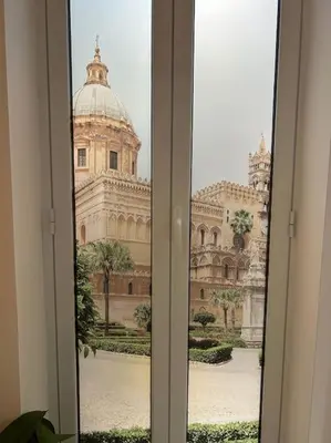 a view of a large building through a window at Alfa & Omega apartments in Palermo