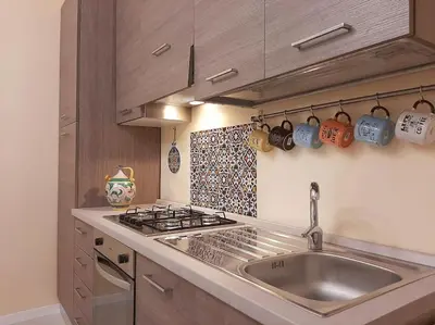 a kitchen with a sink and a stove at Corso Alberto in terrazza Palermo in Palermo