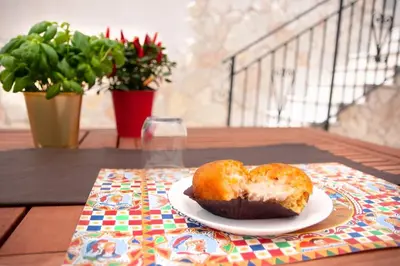 a donut sitting on a plate on a table at Corso Alberto in terrazza Palermo in Palermo