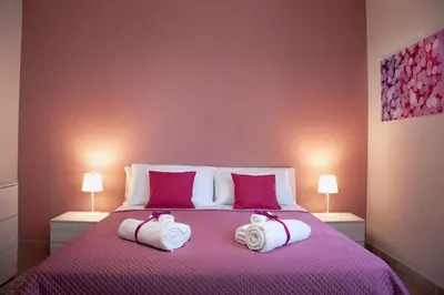 a bedroom with a bed with two towels on it at Corso Alberto in terrazza Palermo in Palermo