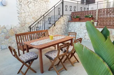 a wooden table and chairs on a patio at Corso Alberto in terrazza Palermo in Palermo