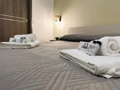 a large bed with towels on top of it at Ai Papiri in Palermo