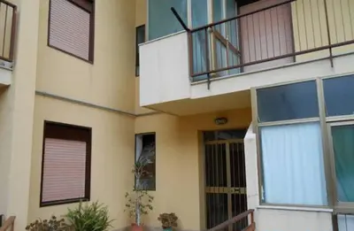 a building with large windows and a balcony at Camera a Palermo in Mondello
