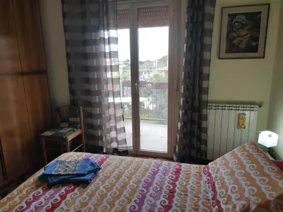 a bedroom with a bed and a window with a view at Camera a Palermo in Mondello