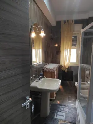 a bathroom with a sink and a mirror at Camera a Palermo in Mondello