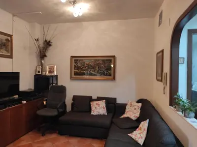 a living room with a couch and a chair at Camera a Palermo in Mondello