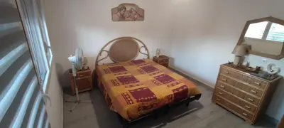 a bedroom with a bed and a dresser and a mirror at Villa Sole in Palermo