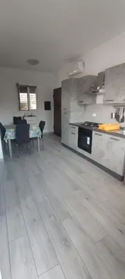 a living room with a kitchen and a dining table at Villa Sole in Palermo