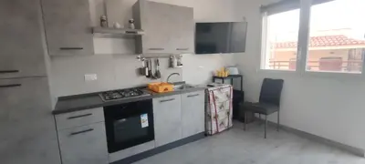 a small kitchen with a stove and a sink at Villa Sole in Palermo