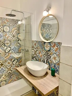 a bathroom with a sink and a mirror at Central Apartment - Le Burnie in Palermo