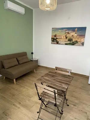 a living room with a couch and a table at Dai Palermitani Rooms & Apartments in Palermo
