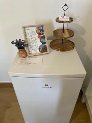 a white refrigerator with a menu on top of it at Dai Palermitani Rooms & Apartments in Palermo