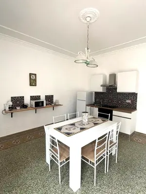 a dining room with a white table and chairs at Casa Marì Holiday House in Palermo
