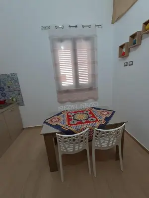 a table and chairs in a kitchen with a window at Casa Vacanza Giulia in Castellammare del Golfo