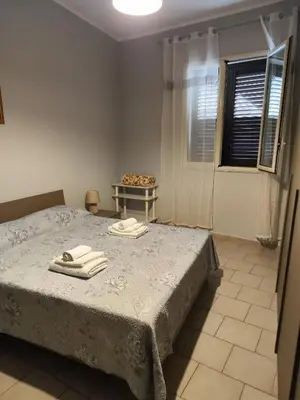 a bedroom with a bed with two towels on it at Casa Felice in Misilmeri