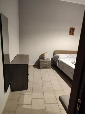 a bedroom with a bed and a dresser and a desk at Casa Felice in Misilmeri