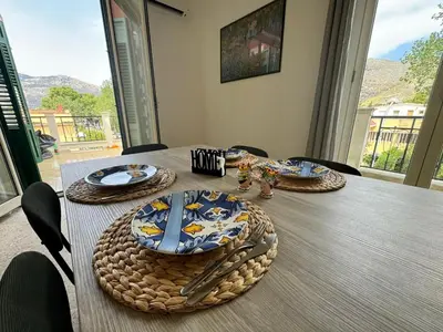 a table with plates and utensils on top of it at Catilì Apartment in Palermo