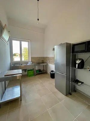 a kitchen with a stainless steel refrigerator and a window at Catilì Apartment in Palermo