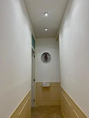 an empty hallway with a clock on the wall at Catilì Apartment in Palermo