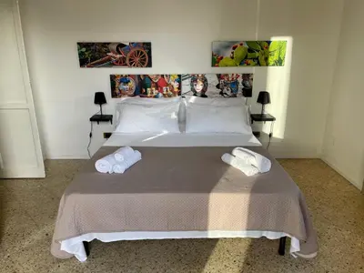 a bedroom with a bed with two towels on it at Catilì Apartment in Palermo