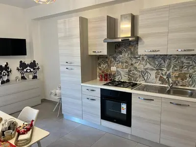 a kitchen with a stove and a sink in it at Terrasini Sea in Terrasini
