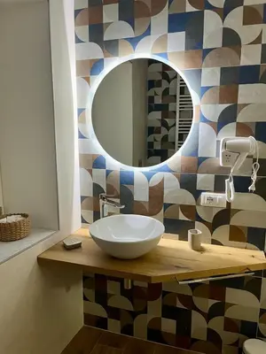 a bathroom with a sink and a mirror at Al Duomo Suites in Monreale