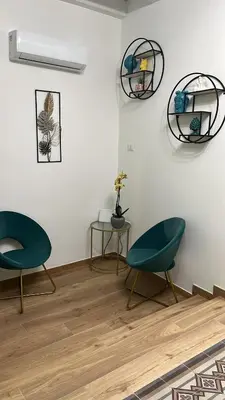 two chairs and a table in a room at Al Duomo Suites in Monreale