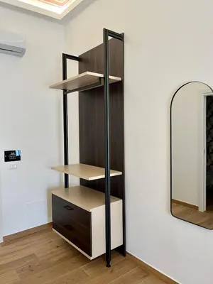 a shelf in a room next to a mirror at Al Duomo Suites in Monreale