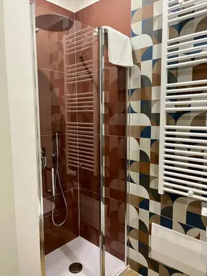 a bathroom with a shower with a glass door at Al Duomo Suites in Monreale