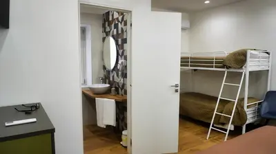 a room with a bunk bed and a bathroom at Al Duomo Suites in Monreale