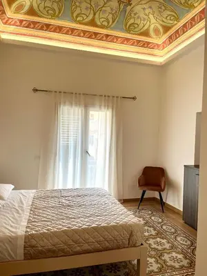 a bedroom with a bed with a gold ceiling at Al Duomo Suites in Monreale