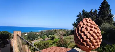 a sculpture of a pineapple sitting on top of a house at Costa Azzurra Cefalù Residence in Cefalù